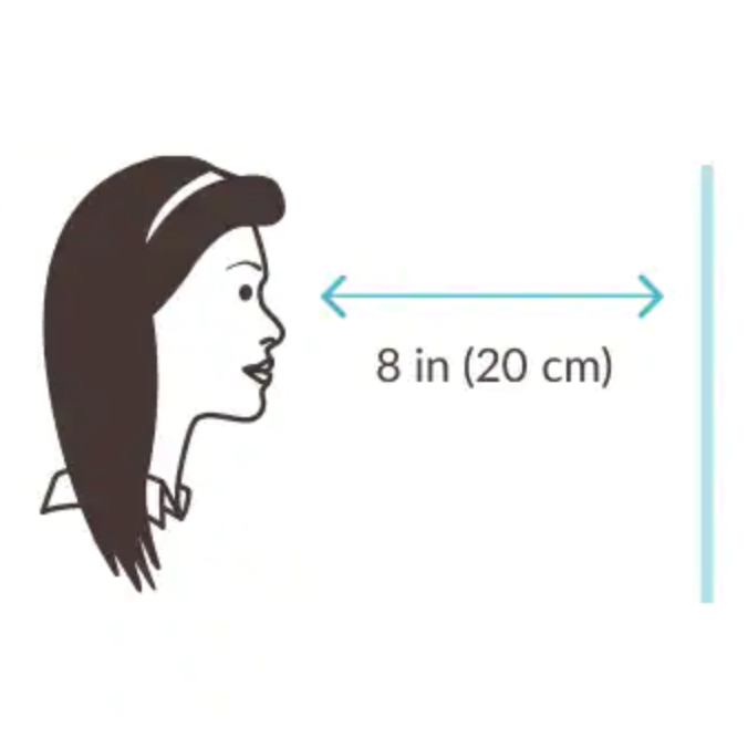 Stand 8 inches (20 cm) away from a mirror or a friend. Place & hold the PD ruler against your brow. Keep your face straight.